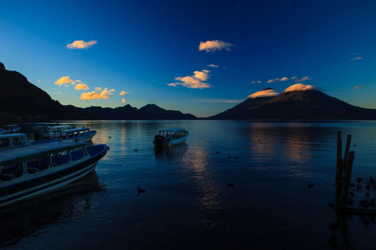 Sunrise over Lake Atitlán with boats